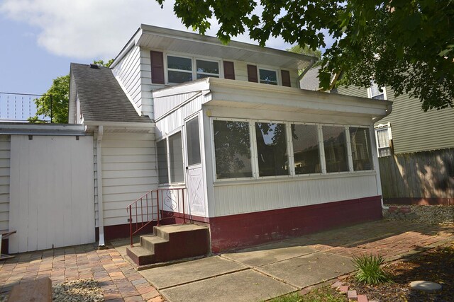 610 E Main St, Ottawa, IL 61350 - view of front of property featuring a sunroom, a patio, and a shingled roof