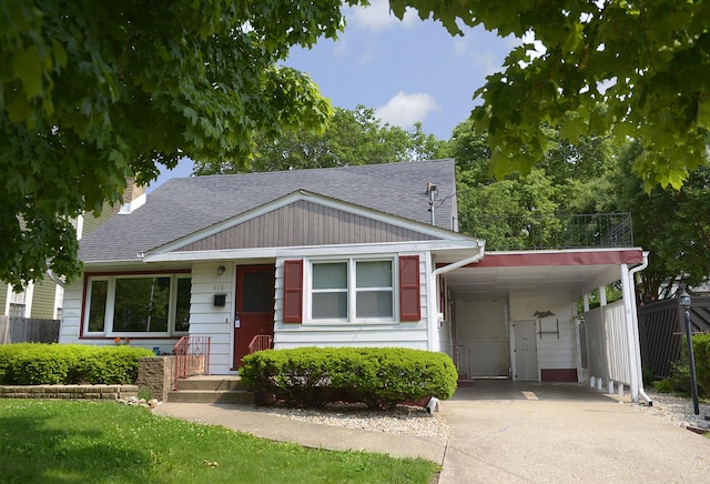 610 E Main St, Ottawa, IL 61350 - view of front of property featuring driveway, a shingled roof, a carport, and a chimney