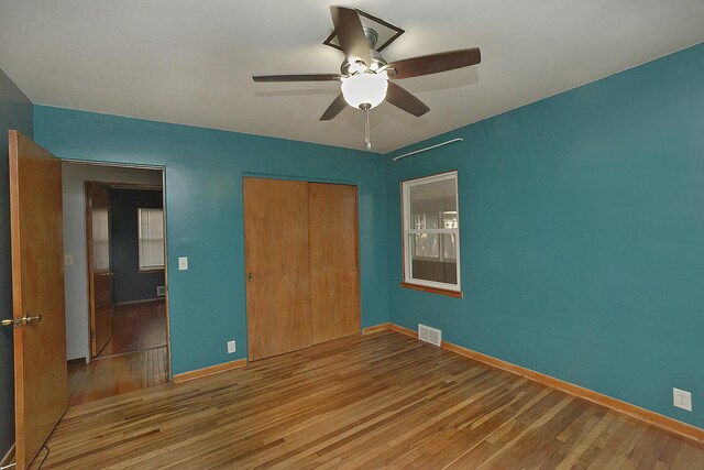 610 E Main St, Ottawa, IL 61350 - unfurnished bedroom featuring wood finished floors, a closet, baseboards, and ceiling fan