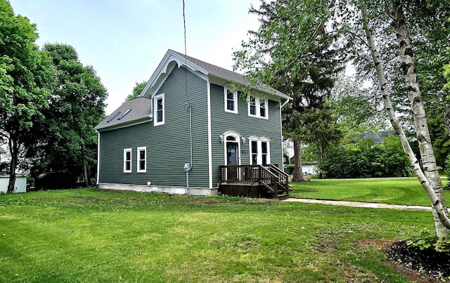 view of side of property with a lawn and a shingled roof