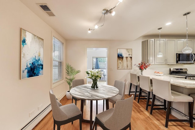 5319 W Cullom Ave, Chicago, IL 60641 - dining space featuring baseboard heating and light wood-style floors
