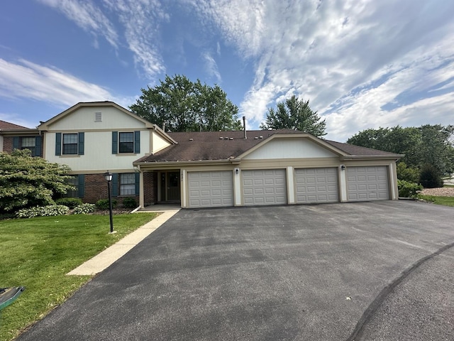 1021 Boxwood Ct Unit C1, Wheeling, IL 60090 - view of front of home with driveway, a garage, brick siding, and a front lawn