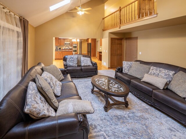 1707 Frediani Ct, Mount Prospect, IL 60056 - living room featuring ceiling fan, a skylight, and high vaulted ceiling