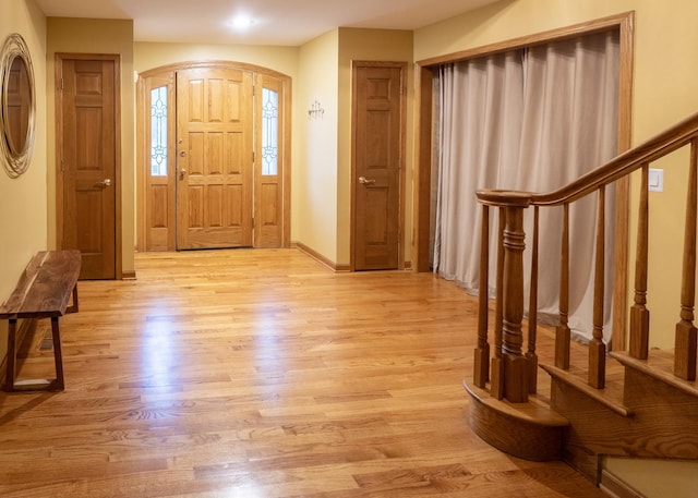 1707 Frediani Ct, Mount Prospect, IL 60056 - foyer with light wood-style floors, stairway, baseboards, and arched walkways