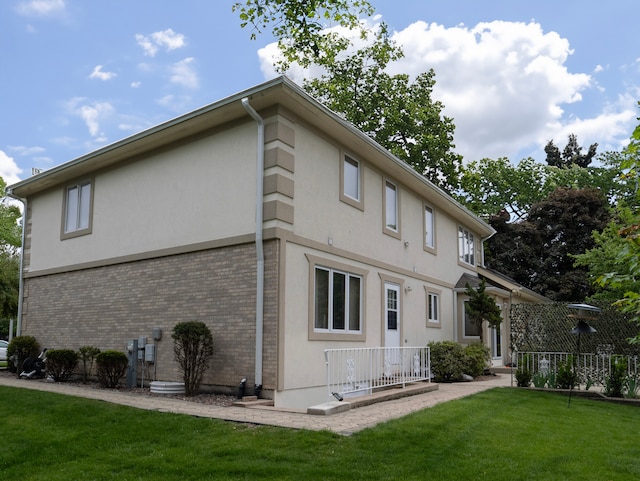 1707 Frediani Ct, Mount Prospect, IL 60056 - rear view of property featuring stucco siding, a yard, and brick siding