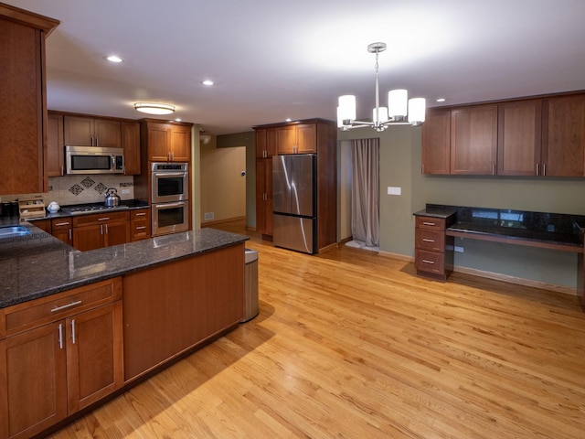 1707 Frediani Ct, Mount Prospect, IL 60056 - kitchen with stainless steel appliances, light wood-style floors, a chandelier, pendant lighting, and tasteful backsplash