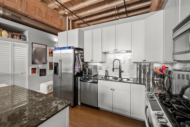 2545 S Dearborn St Unit 405, Chicago, IL 60616 - kitchen featuring appliances with stainless steel finishes, tasteful backsplash, and white cabinetry
