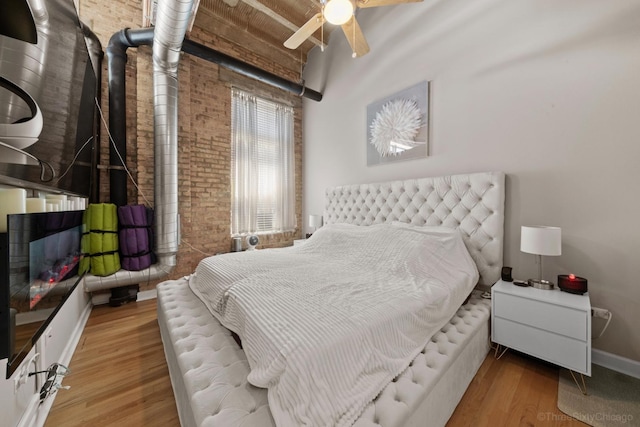 2545 S Dearborn St Unit 405, Chicago, IL 60616 - bedroom featuring brick wall, wood finished floors, and a ceiling fan