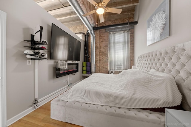 2545 S Dearborn St Unit 405, Chicago, IL 60616 - bedroom featuring brick wall and wood finished floors