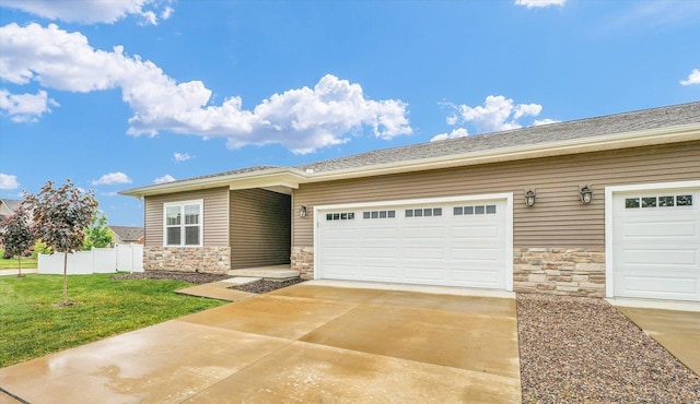 3311 Memory Ln E, Unit East, Urbana, IL 61802 - view of front of home with stone siding, concrete driveway, and a garage