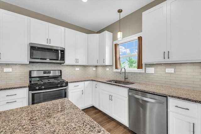 3311 Memory Ln E, Unit East, Urbana, IL 61802 - kitchen featuring appliances with stainless steel finishes, a sink, light stone countertops, and white cabinets