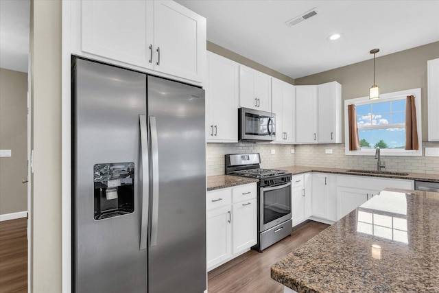 3311 Memory Ln E, Unit East, Urbana, IL 61802 - kitchen with appliances with stainless steel finishes, a sink, dark wood finished floors, tasteful backsplash, and white cabinetry