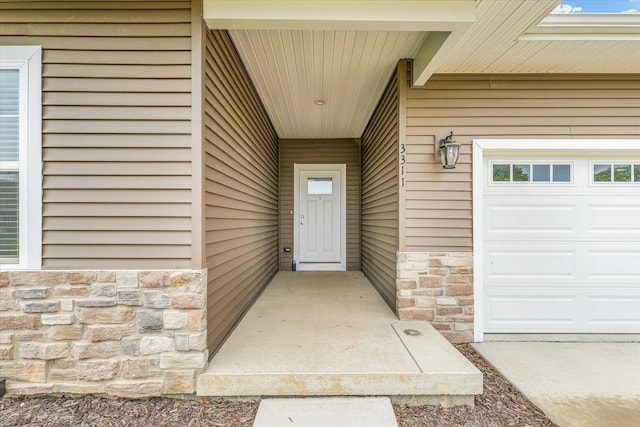 3311 Memory Ln E, Unit East, Urbana, IL 61802 - property entrance with stone siding and a garage