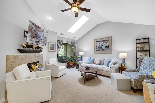 986 W Ct Unit C, Naperville, IL 60563 - living room featuring a ceiling fan, a skylight, a tiled fireplace, carpet flooring, and high vaulted ceiling