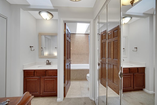 986 W Ct Unit C, Naperville, IL 60563 - full bath with two vanities, a tub to relax in, toilet, a shower, and tile patterned floors