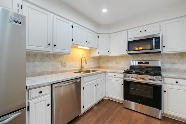3350 N Carriageway Dr Unit 208, Arlington Heights, IL 60004 - kitchen with appliances with stainless steel finishes, a sink, white cabinetry, dark wood finished floors, and backsplash