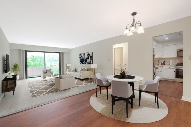 3350 N Carriageway Dr Unit 208, Arlington Heights, IL 60004 - dining area featuring a chandelier, wood finished floors, and baseboards