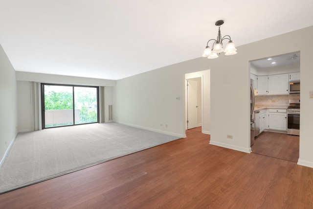 3350 N Carriageway Dr Unit 208, Arlington Heights, IL 60004 - unfurnished living room featuring a chandelier, baseboards, and light wood finished floors