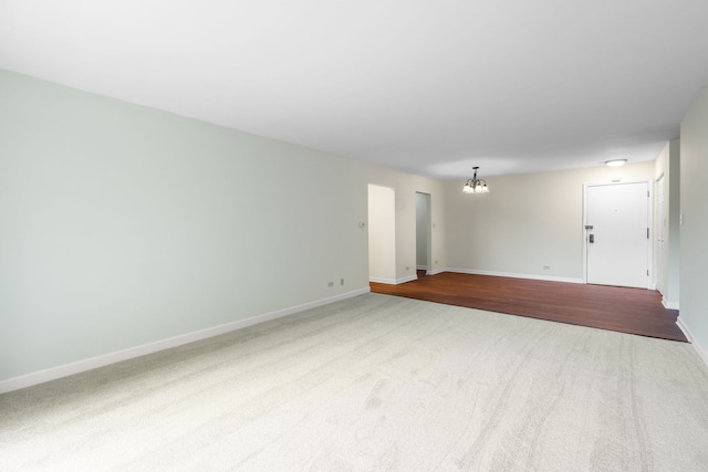 3350 N Carriageway Dr Unit 208, Arlington Heights, IL 60004 - unfurnished room featuring a chandelier, carpet floors, and baseboards