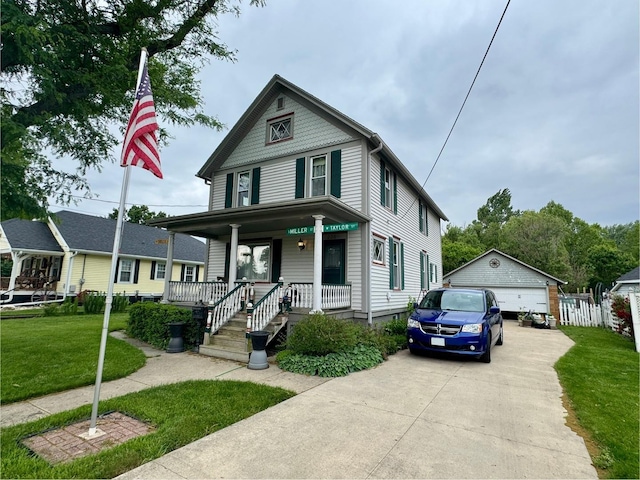 236 S Randolph St, Princeton, IL 61356 - victorian house featuring covered porch, a detached garage, a front yard, and an outdoor structure