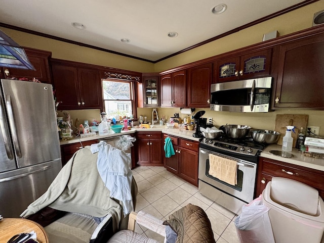 236 S Randolph St, Princeton, IL 61356 - kitchen featuring stainless steel appliances, light countertops, light tile patterned flooring, glass insert cabinets, and ornamental molding