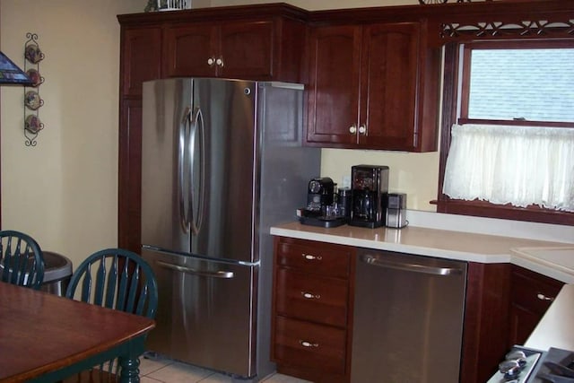 236 S Randolph St, Princeton, IL 61356 - kitchen featuring stainless steel appliances, light countertops, light tile patterned flooring, glass insert cabinets, and ornamental molding