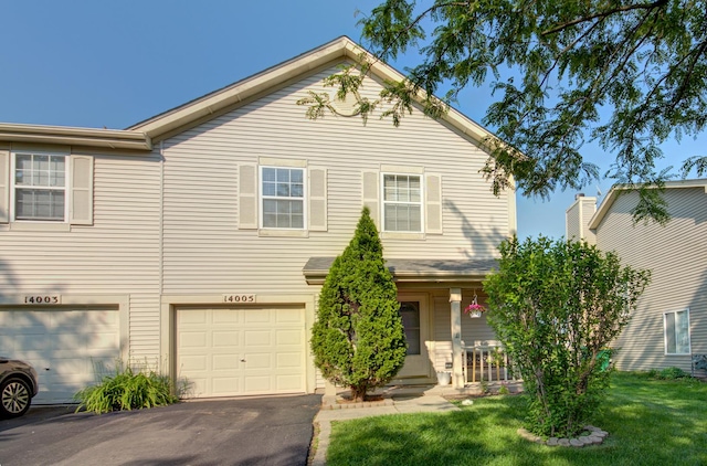 14005 Danbury Dr, Plainfield, IL 60544 - view of front facade with driveway, covered porch, an attached garage, and a front yard