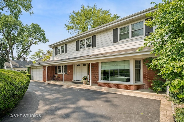 2620 Marian Ln, Wilmette, IL 60091 - view of front facade featuring a garage, brick siding, and driveway