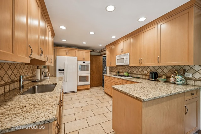 2620 Marian Ln, Wilmette, IL 60091 - kitchen featuring white appliances, a peninsula, light stone counters, recessed lighting, and tasteful backsplash