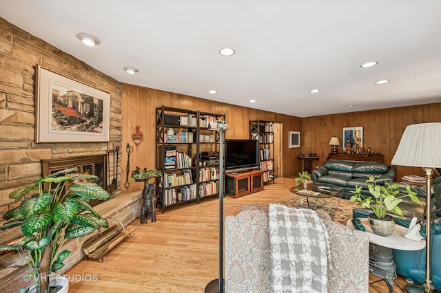 2620 Marian Ln, Wilmette, IL 60091 - living room featuring wood walls, wood finished floors, a lit fireplace, and recessed lighting