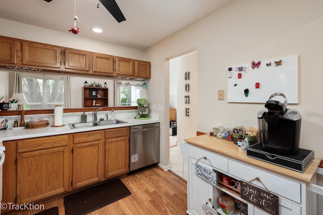 1312 Shawford Way Unit 1312, Elgin, IL 60120 - kitchen featuring a sink, stainless steel dishwasher, light wood-type flooring, light countertops, and brown cabinets
