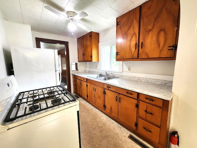 1198 E Bluff St, Marseilles, IL 61341 - kitchen featuring white appliances, a sink, light countertops, and brown cabinetry