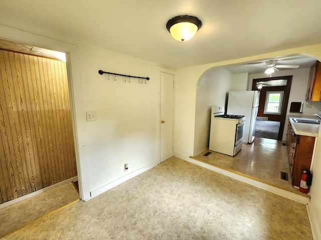 1198 E Bluff St, Marseilles, IL 61341 - kitchen with arched walkways, white appliances, a ceiling fan, and light countertops