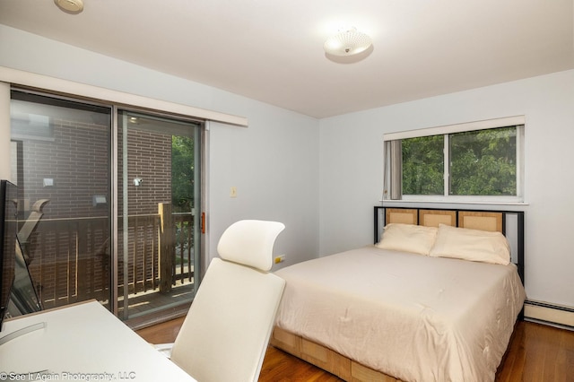 417 S Kenilworth Ave Unit 7, Oak Park, IL 60302 - bedroom featuring access to exterior, wood finished floors, and baseboard heating