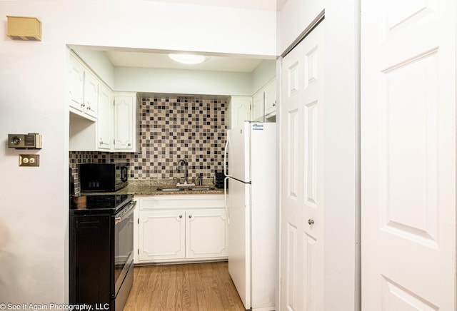 417 S Kenilworth Ave Unit 7, Oak Park, IL 60302 - kitchen featuring electric range, freestanding refrigerator, black microwave, white cabinetry, and decorative backsplash