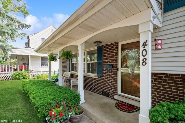 408 S Cedar Rd, New Lenox, IL 60451 - property entrance featuring a porch and brick siding