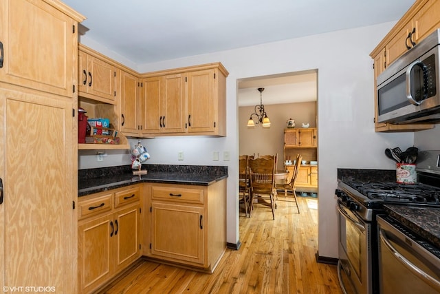 408 S Cedar Rd, New Lenox, IL 60451 - kitchen with stainless steel appliances, light wood finished floors, a chandelier, and dark stone countertops