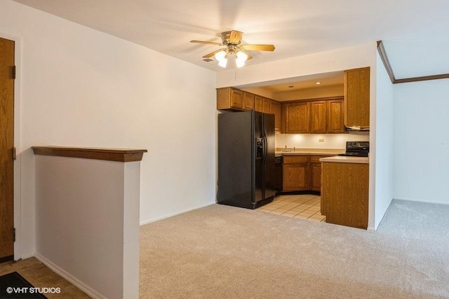 6700 S Brainard Ave Unit 104, Countryside, IL 60525 - kitchen with black fridge, brown cabinetry, light carpet, and stove