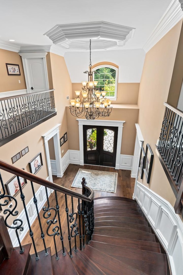 655 Thornwood Dr, Naperville, IL 60540 - foyer featuring a chandelier, crown molding, a wainscoted wall, wood-type flooring, and a decorative wall
