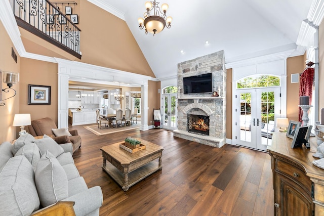 655 Thornwood Dr, Naperville, IL 60540 - living area with high vaulted ceiling, a chandelier, french doors, dark wood-style floors, and ornate columns