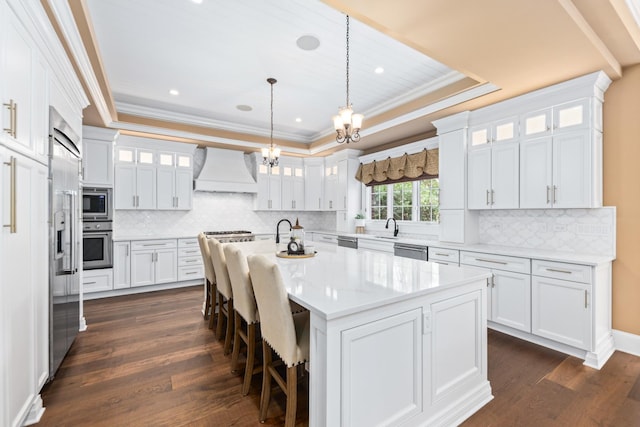 655 Thornwood Dr, Naperville, IL 60540 - kitchen with custom exhaust hood, built in appliances, crown molding, white cabinetry, and dark wood-type flooring