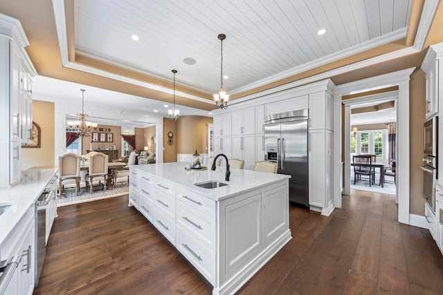 655 Thornwood Dr, Naperville, IL 60540 - kitchen featuring built in appliances, a sink, a chandelier, a raised ceiling, and dark wood finished floors
