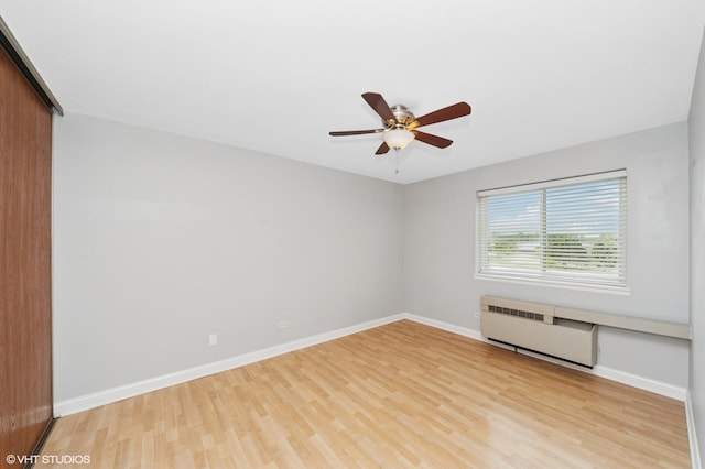 5600 Astor Ln Unit 301, Rolling Meadows, IL 60008 - unfurnished room featuring light wood-style flooring, radiator, ceiling fan, and baseboards