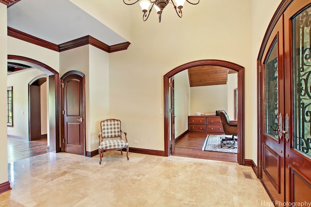 273 Donlea Rd, Barrington Hills, IL 60010 - foyer entrance featuring arched walkways, a chandelier, ornamental molding, and baseboards