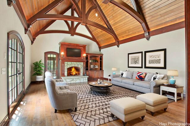 273 Donlea Rd, Barrington Hills, IL 60010 - living room featuring a lit fireplace, wooden ceiling with exposed beams, high vaulted ceiling, hardwood / wood-style flooring, and baseboards