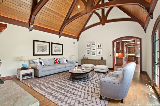 273 Donlea Rd, Barrington Hills, IL 60010 - living area featuring arched walkways, hardwood / wood-style floors, wood ceiling with exposed beams, high vaulted ceiling, and baseboards