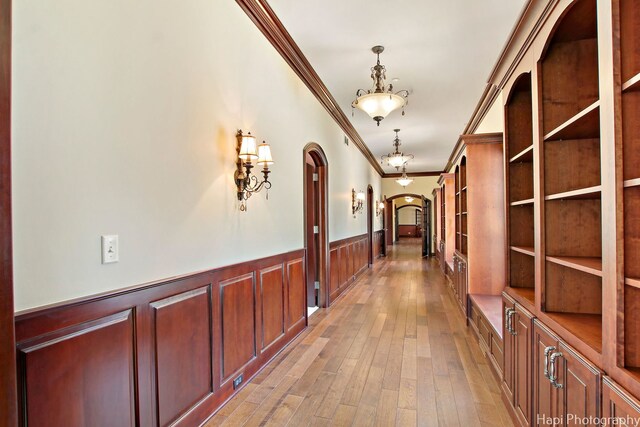 273 Donlea Rd, Barrington Hills, IL 60010 - hallway featuring arched walkways, crown molding, wainscoting, and light wood-style flooring