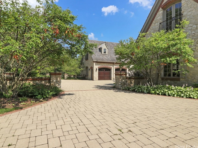 273 Donlea Rd, Barrington Hills, IL 60010 - view of front of house featuring stone siding, decorative driveway, a high end roof, and a garage