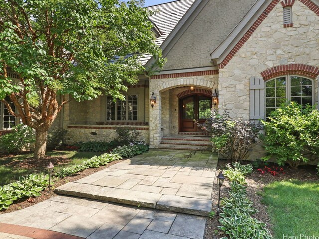 273 Donlea Rd, Barrington Hills, IL 60010 - view of exterior entry featuring stone siding, a high end roof, and french doors