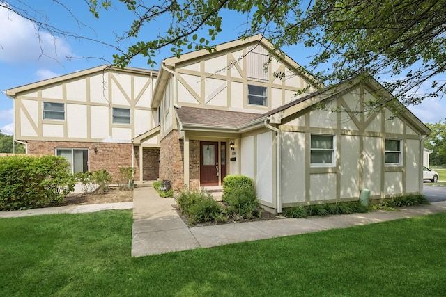 830 E Hillside Ave Unit 830, Barrington, IL 60010 - english style home featuring stucco siding, a front yard, and brick siding